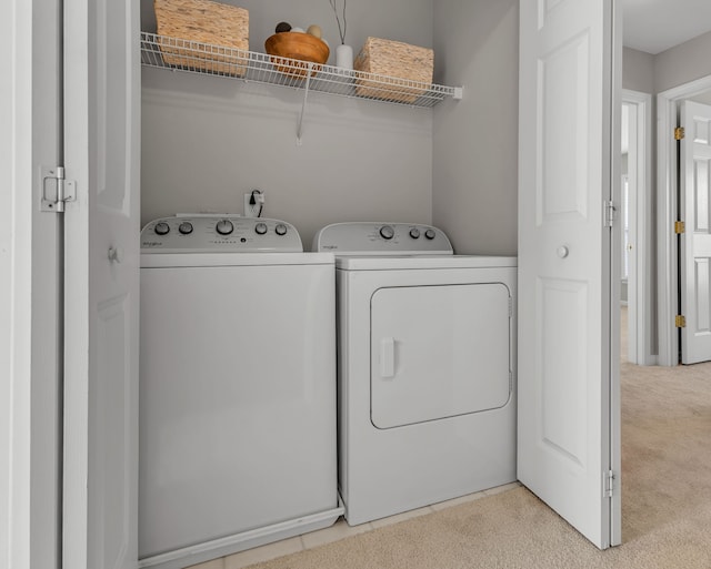 laundry area with washer and dryer and carpet