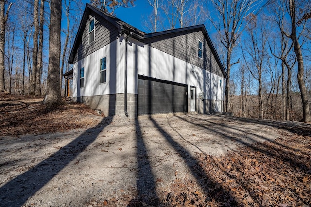 view of home's exterior with concrete driveway