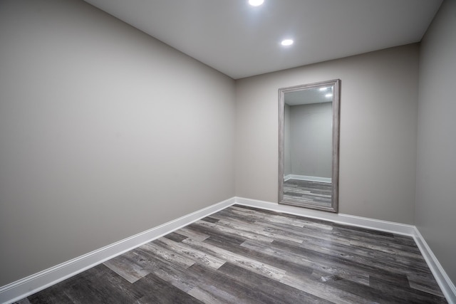 empty room with recessed lighting, baseboards, and dark wood-style floors