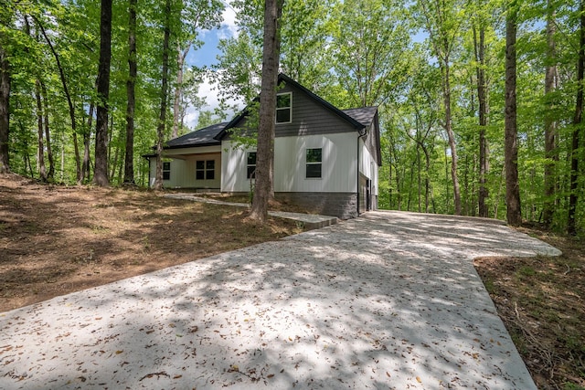 view of side of home with driveway