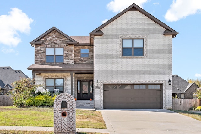 view of front of property featuring a front yard and a garage