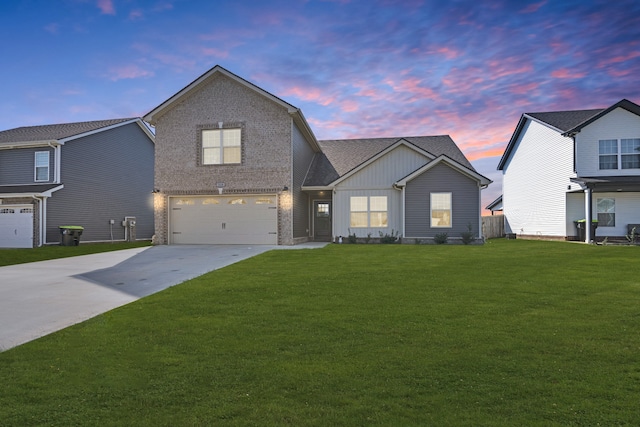 view of front of property featuring a lawn and a garage