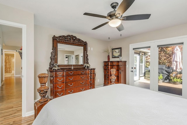 bedroom with ceiling fan, baseboards, access to outside, and wood finished floors