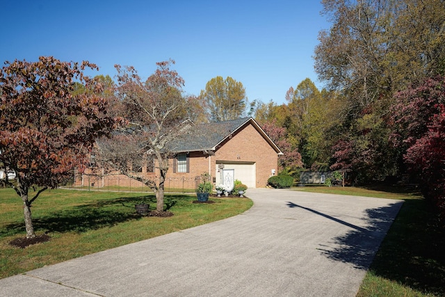 ranch-style house with a garage, driveway, a front lawn, and brick siding