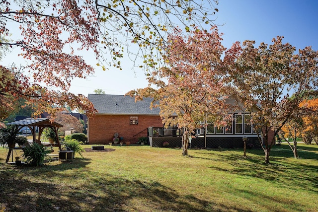view of yard with a wooden deck and a gazebo