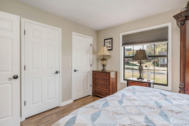 bedroom featuring baseboards and wood finished floors