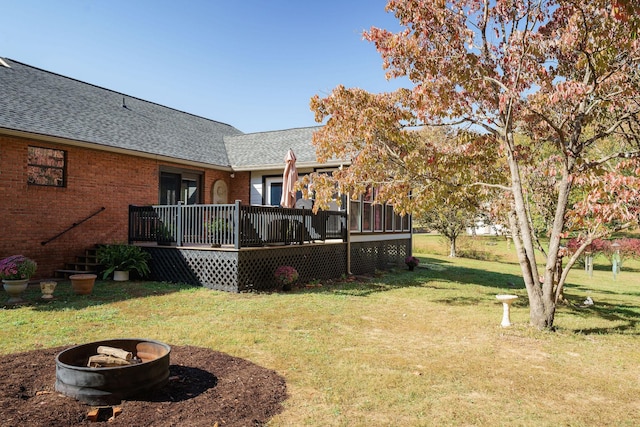 view of yard with a fire pit and a deck