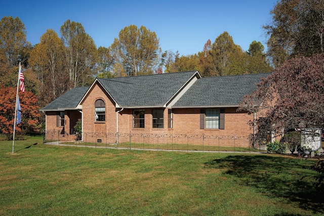 ranch-style house with brick siding, a shingled roof, a front yard, and fence