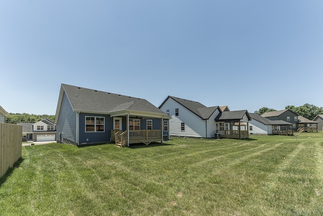 rear view of house featuring cooling unit and a lawn