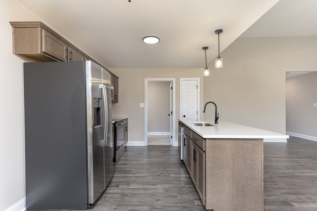 kitchen featuring sink, hanging light fixtures, a kitchen island with sink, stainless steel appliances, and dark wood-type flooring