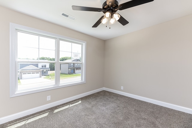 carpeted empty room featuring ceiling fan