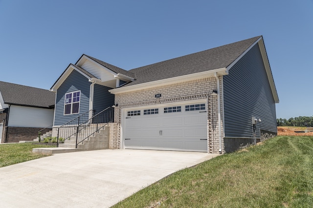 ranch-style home with a garage, a front lawn, brick siding, and driveway