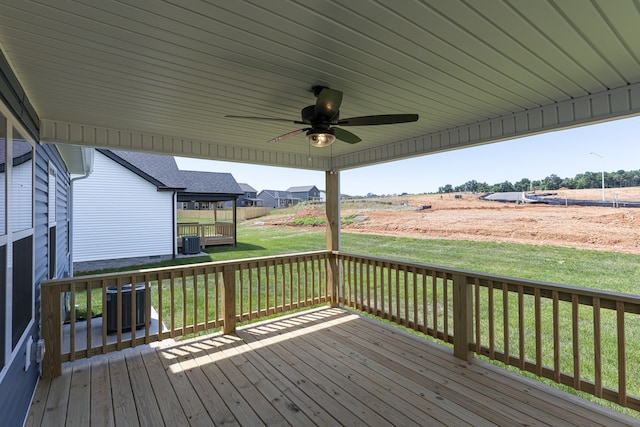 deck with a ceiling fan, a lawn, and central AC