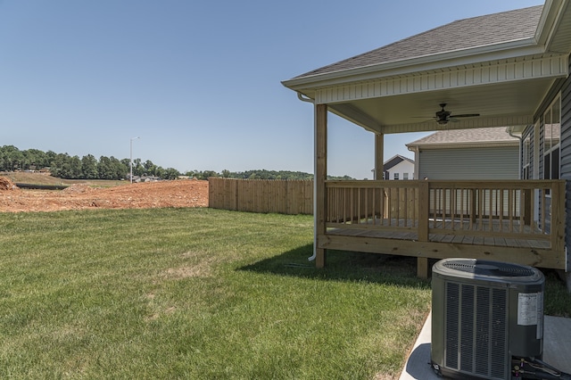 view of yard featuring a wooden deck, ceiling fan, and central AC unit