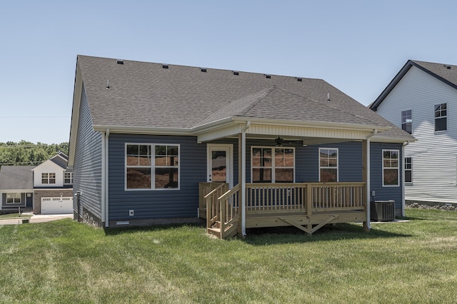 back of property with covered porch, a lawn, ceiling fan, and roof with shingles