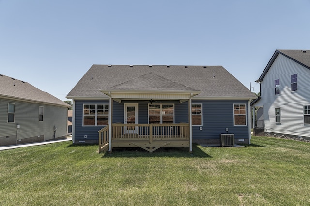 rear view of house featuring a yard, a wooden deck, cooling unit, and a shingled roof