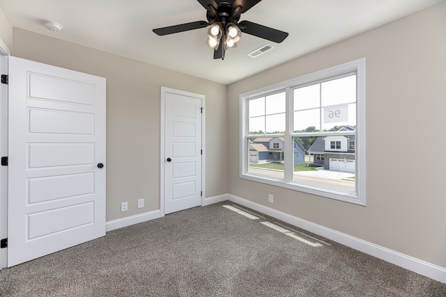 unfurnished bedroom featuring carpet and ceiling fan