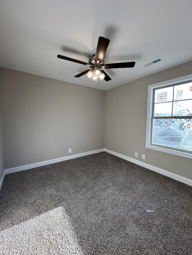 spare room with visible vents, ceiling fan, baseboards, and carpet floors