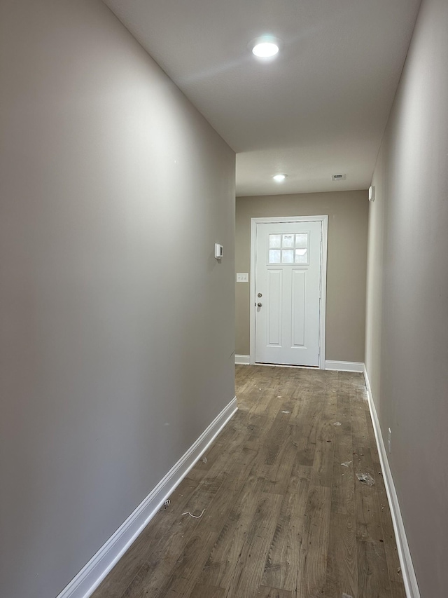 doorway with dark wood-type flooring