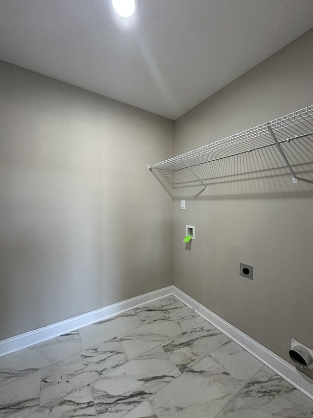 laundry area with electric dryer hookup, baseboards, marble finish floor, and laundry area