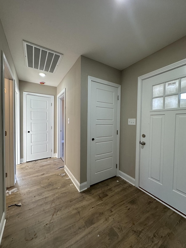 entrance foyer featuring dark wood-style floors, visible vents, and baseboards