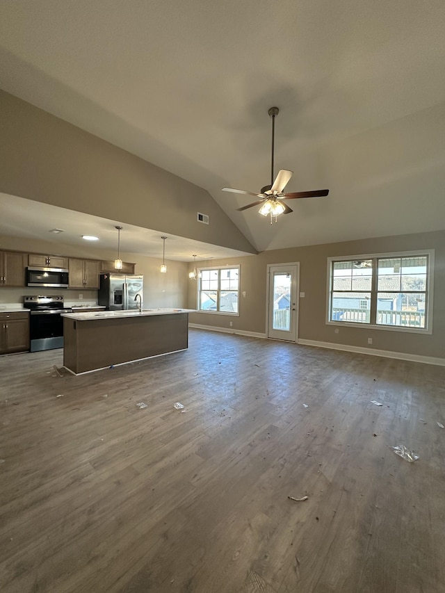 unfurnished living room featuring wood finished floors, visible vents, baseboards, lofted ceiling, and ceiling fan