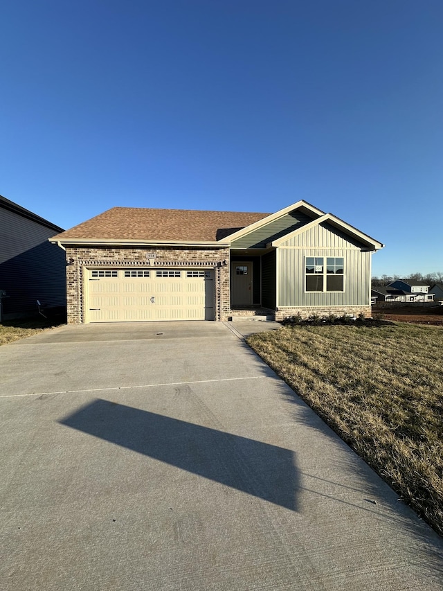 view of front of home featuring brick siding, board and batten siding, a shingled roof, concrete driveway, and a garage