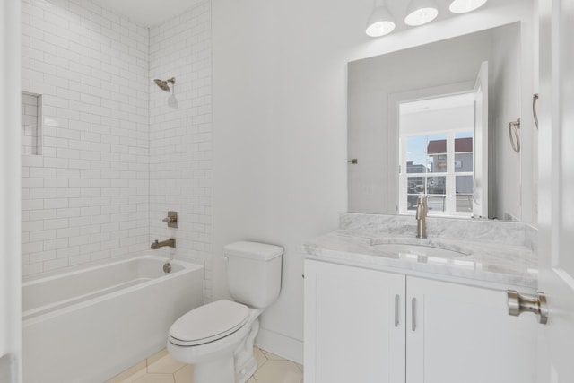 full bathroom with tile patterned floors, toilet, tiled shower / bath combo, and vanity