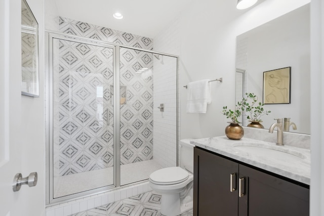 bathroom with a shower with door, toilet, and vanity