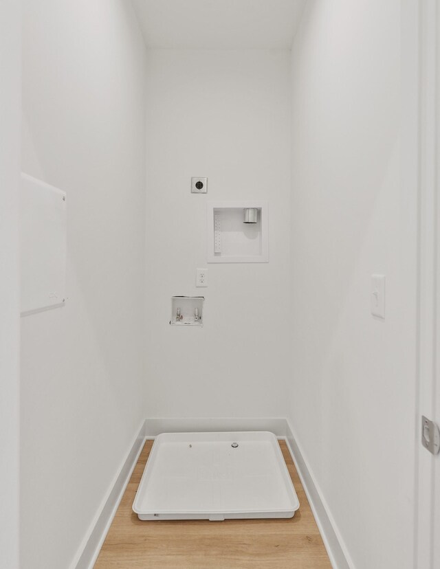 washroom featuring wood-type flooring, hookup for an electric dryer, and hookup for a washing machine