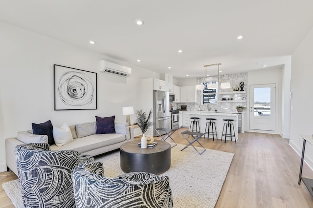 living room featuring light wood-type flooring and an AC wall unit