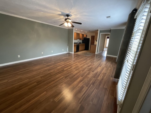 unfurnished living room featuring dark hardwood / wood-style flooring, a textured ceiling, ornamental molding, and ceiling fan