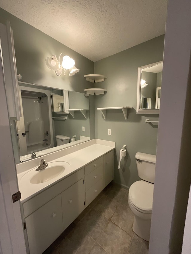 full bathroom featuring vanity, toilet, bathing tub / shower combination, and a textured ceiling