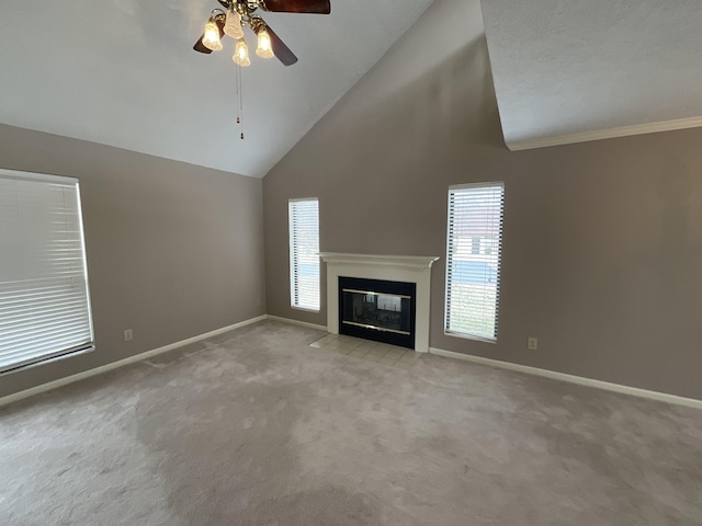 unfurnished living room featuring crown molding, ceiling fan, high vaulted ceiling, and light carpet