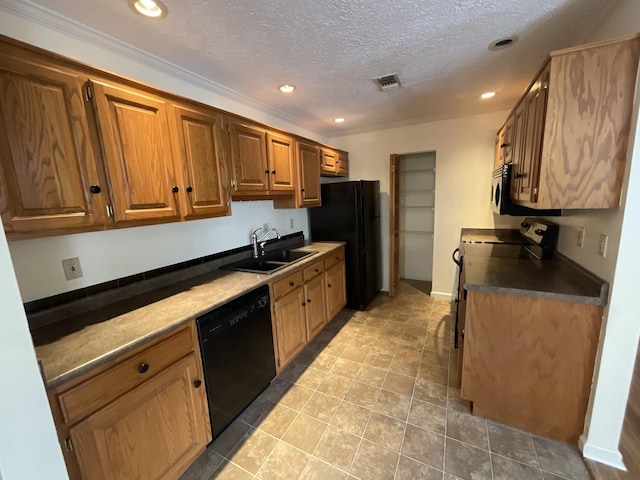 kitchen featuring sink, ornamental molding, black appliances, and a textured ceiling