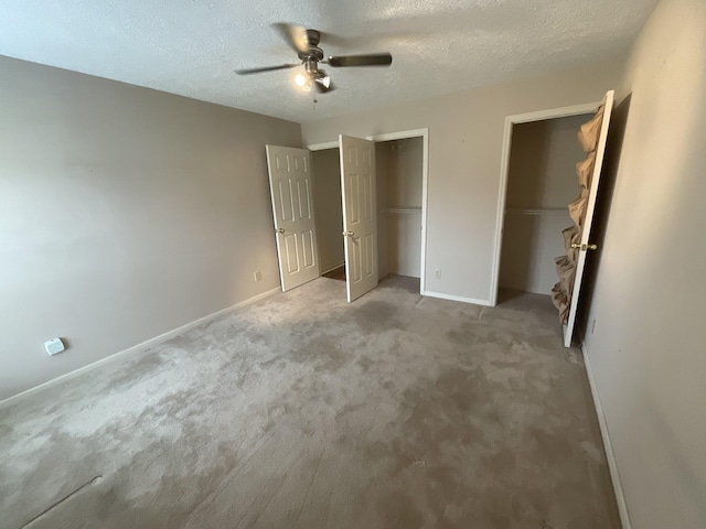 unfurnished bedroom with light colored carpet, a textured ceiling, and ceiling fan