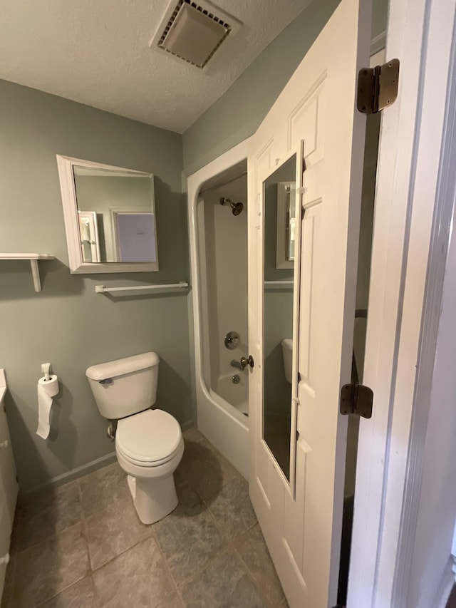 bathroom featuring a textured ceiling and toilet