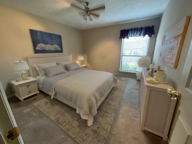 bedroom with ceiling fan and concrete floors