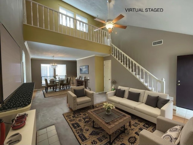 tiled living room with crown molding, a towering ceiling, and a healthy amount of sunlight