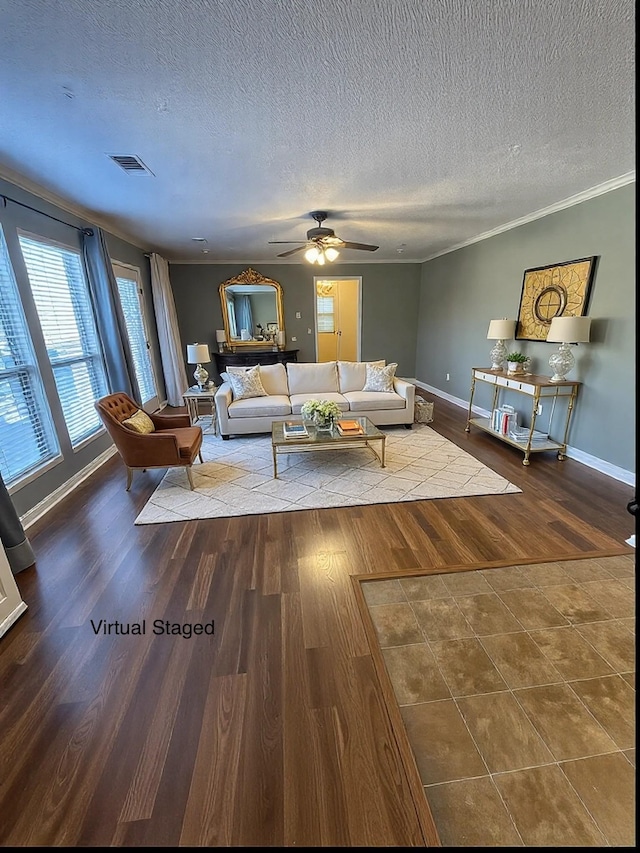 living room featuring hardwood / wood-style flooring, ornamental molding, ceiling fan, and a textured ceiling