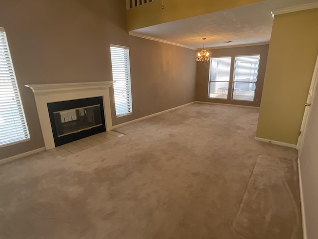 unfurnished living room with ornamental molding, light carpet, and an inviting chandelier