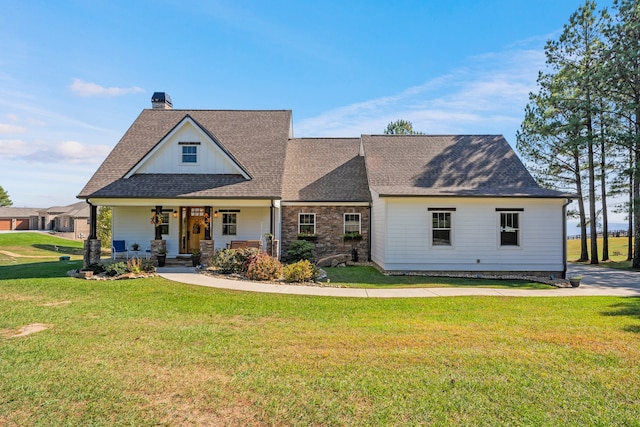 view of front of home with a front yard and covered porch