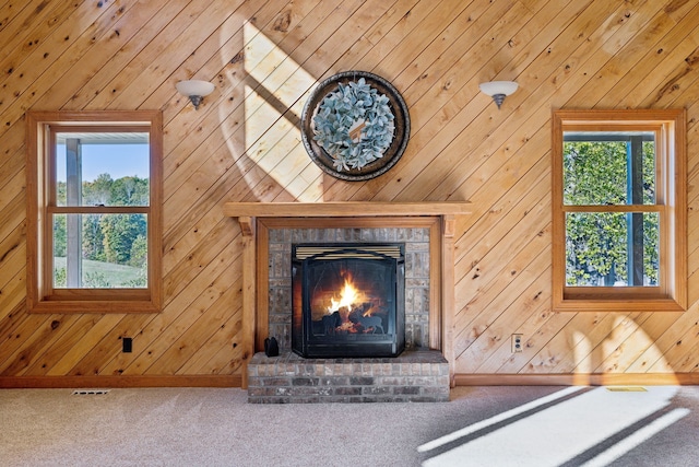 details featuring wood walls, carpet flooring, and a brick fireplace