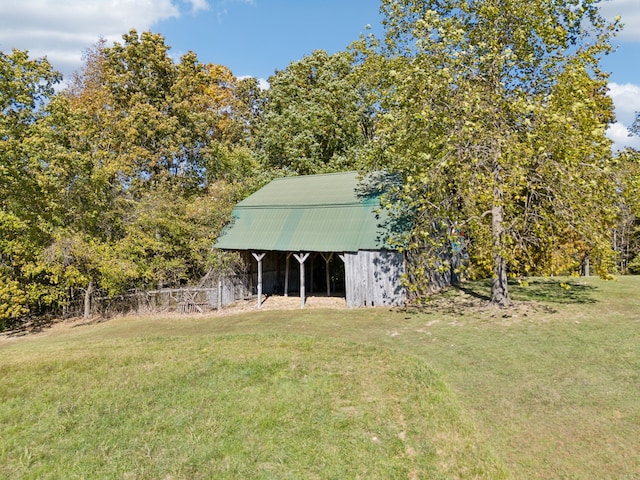 view of outbuilding featuring a lawn