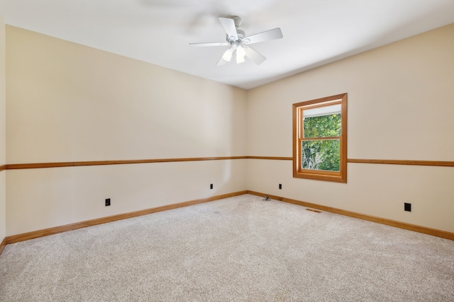 carpeted spare room with ceiling fan