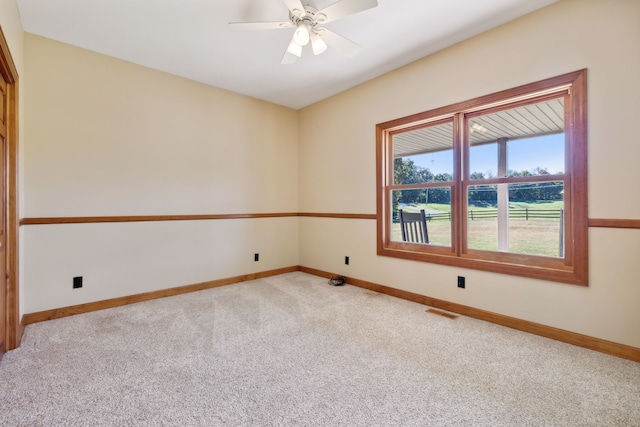 carpeted spare room with ceiling fan