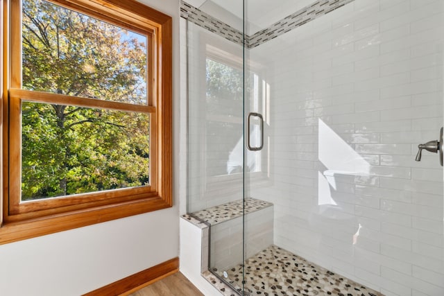 bathroom featuring walk in shower and wood-type flooring