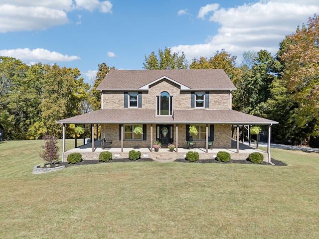 farmhouse with a front lawn and a patio