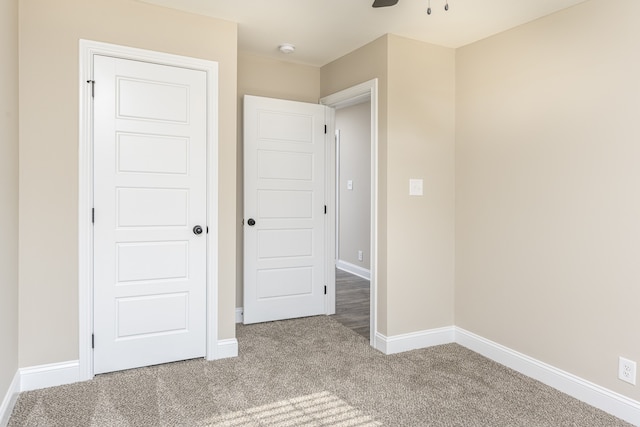 unfurnished bedroom featuring ceiling fan and carpet flooring