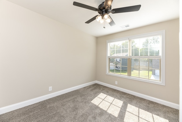 carpeted spare room with ceiling fan